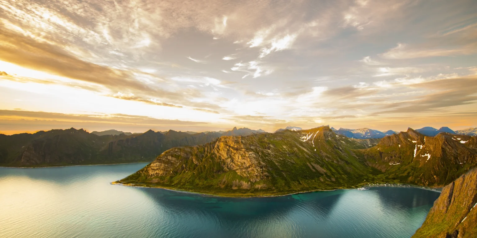 Fjord between green mountains in Northern Norway at sunset